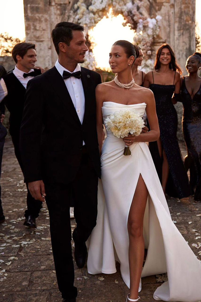 Mlada u venčanici sa šlicem i mladoženja u crnom odelu